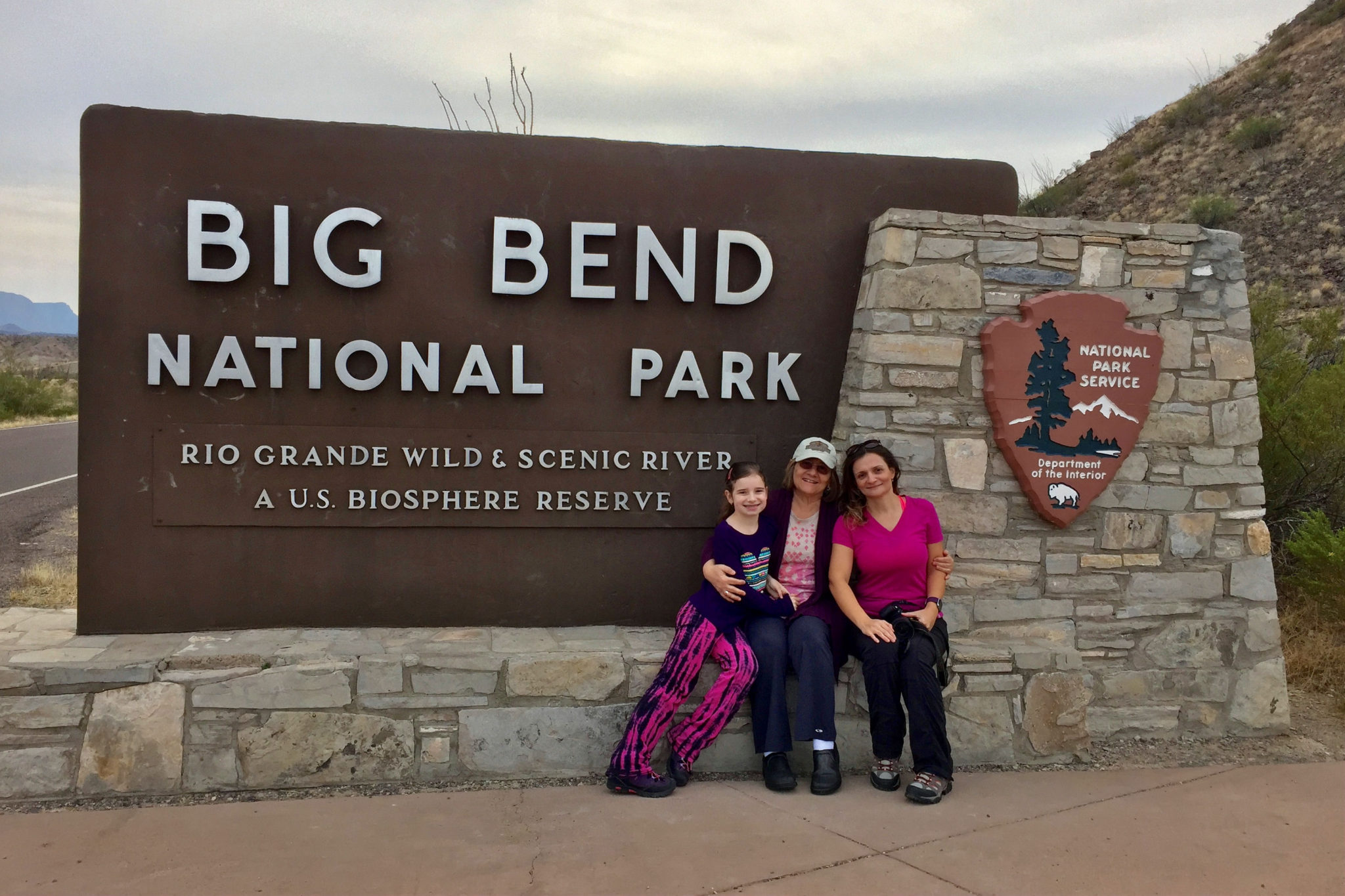 In front of Big Bend National Park sign, one of two national parks in Texas