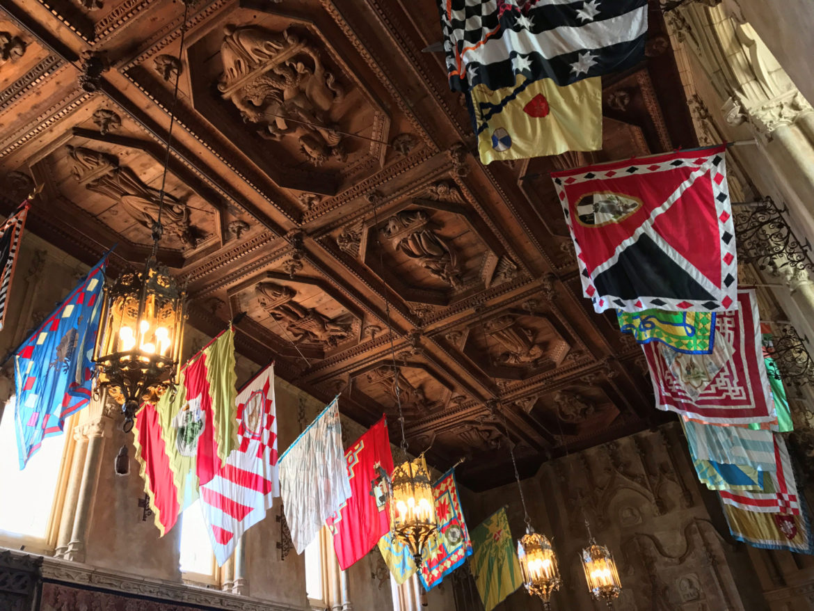 Heraldic flags hanging in the Refectory in Casa Grande