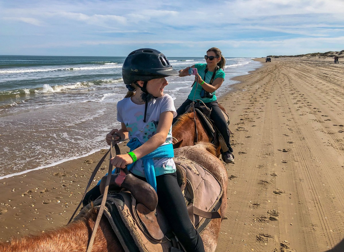 Riding our horses near the water on the beach in South Padre Island