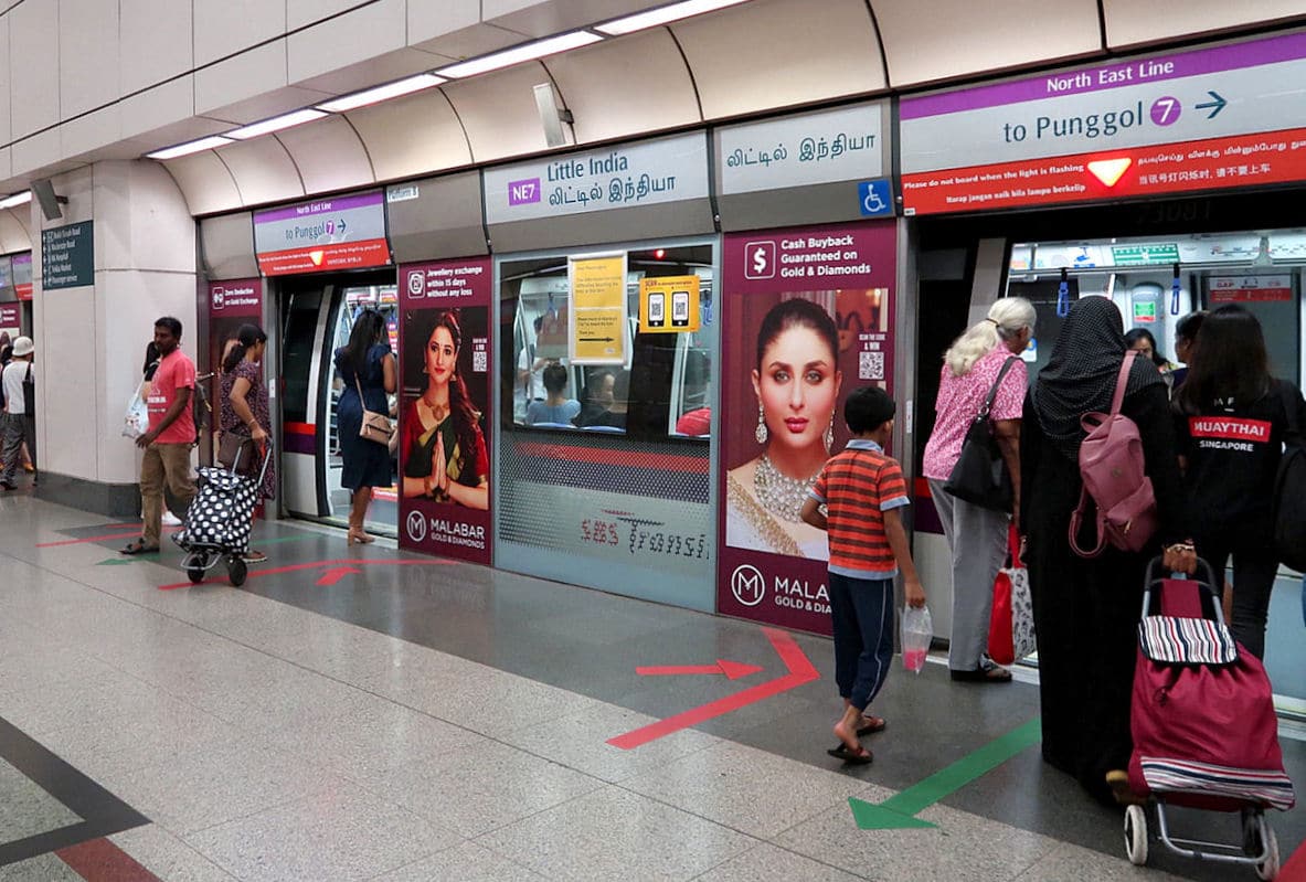 People Getting on a MRT train in Singapore