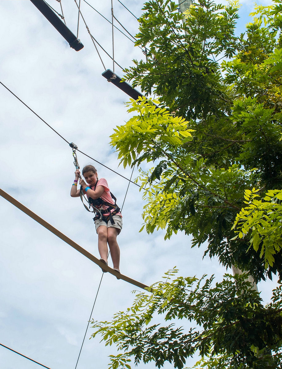 On the hardest level of the high ropes course at Mega Adventure Park Sentosa