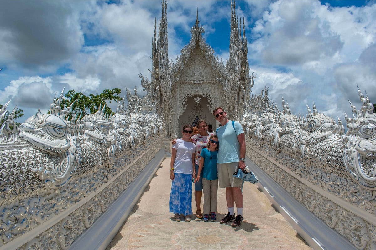 Family photo on the Bridge of the Cycle of Rebirth at the White Temple in Thailand