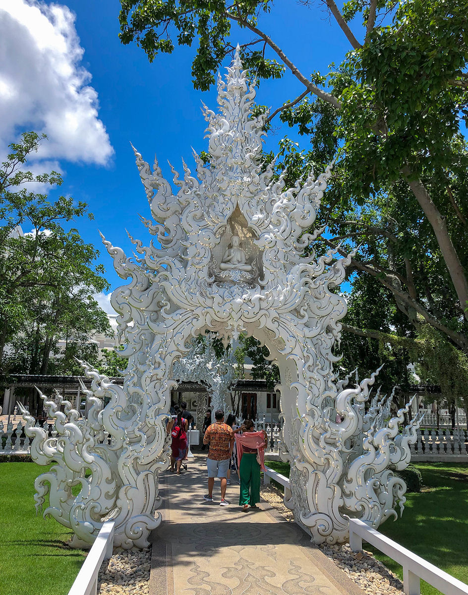 Ornate white arch with Buddha at the White Temple in Thailand