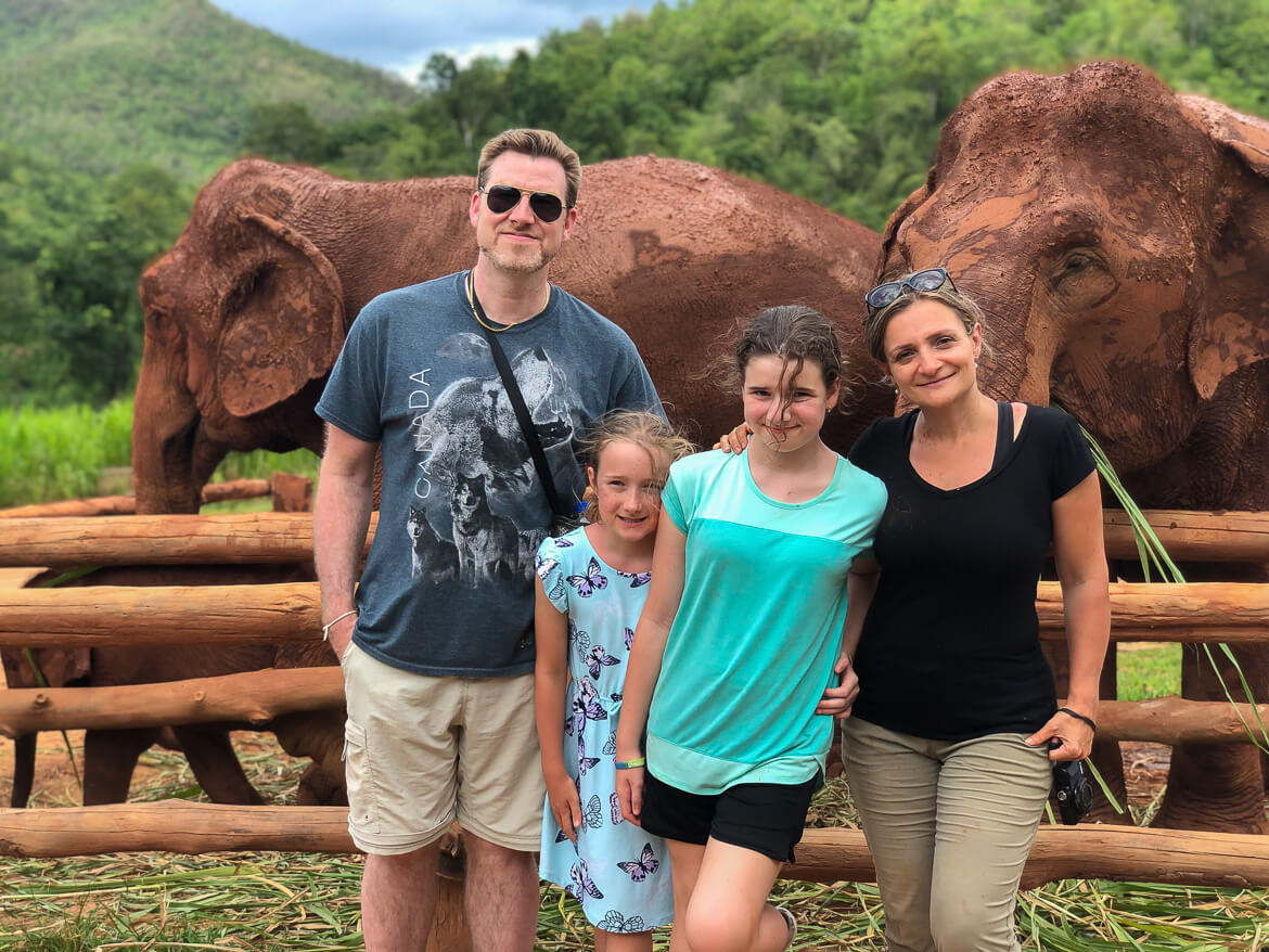 Family photo with elephants at Karen Elephant Serenity Sanctuary in Thailand