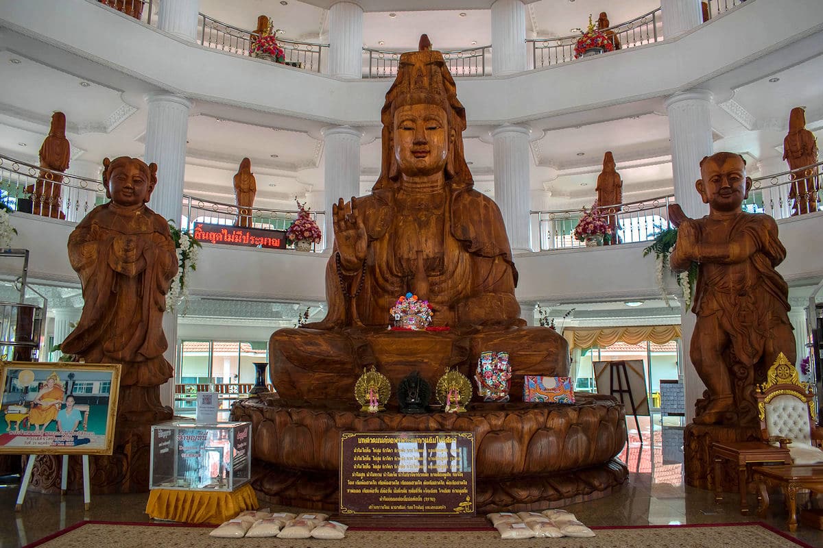 Large wood statue of Guan Yin inside the pagoda at Wat Huay Pla Kang