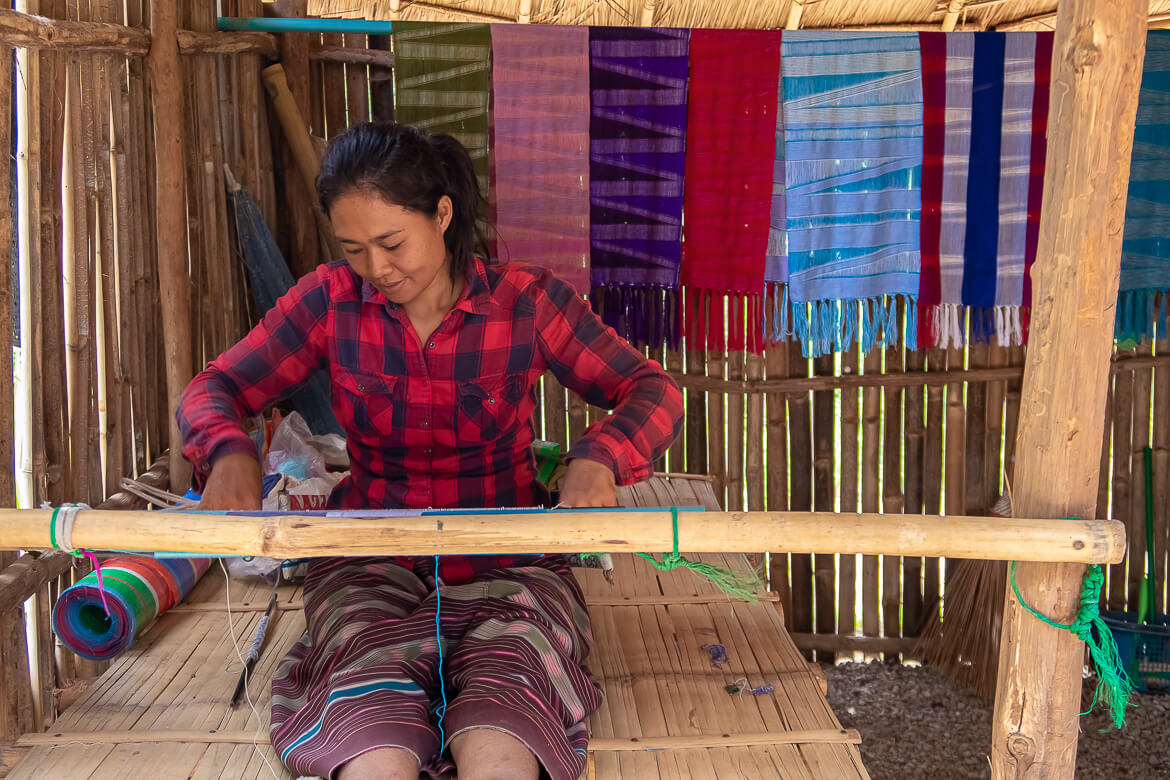 Karen Hilltribe woman making colorful scarves, Thailand