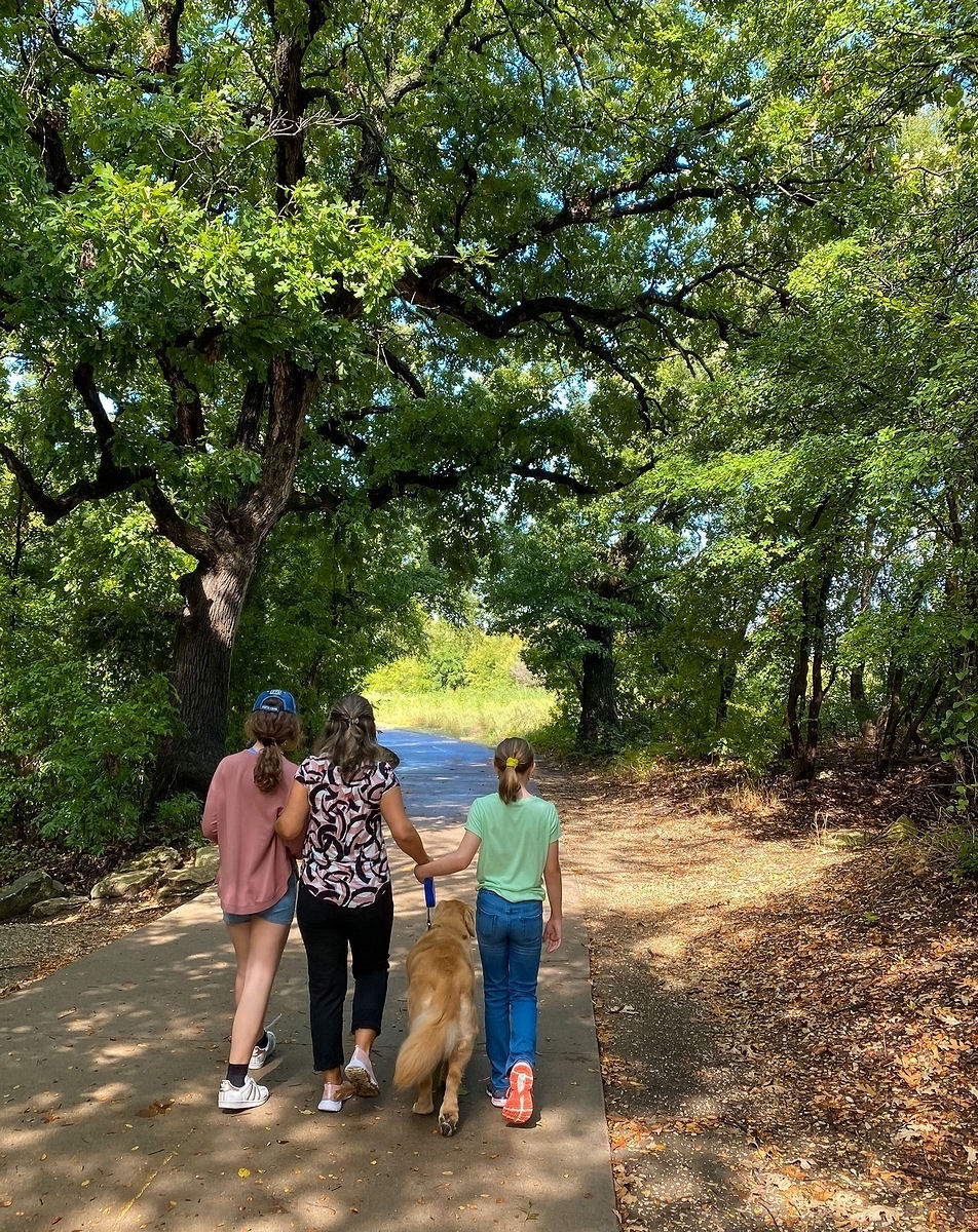 Walking through a "tunnel" of lush green trees in Arbor Hills Nature Preserve