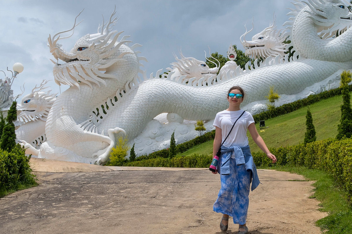 Walking near white dragon sculptures at Wat Huay Pla Kang in Chiang Rai