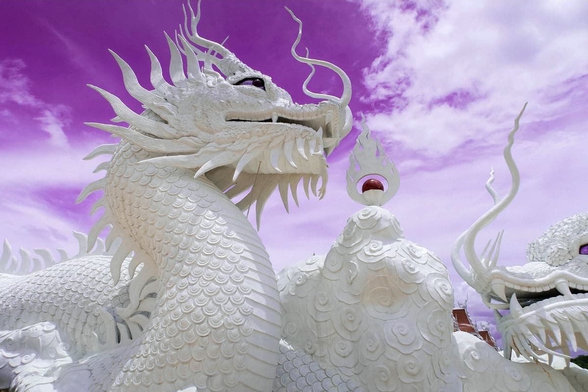White dragon sculptures with purple sky, Wat Huay Pla Kang, Chiang Rai, Thailand